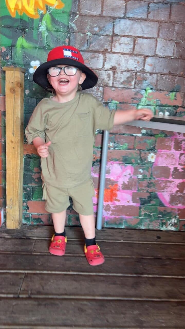 A child we support smiling outdoors