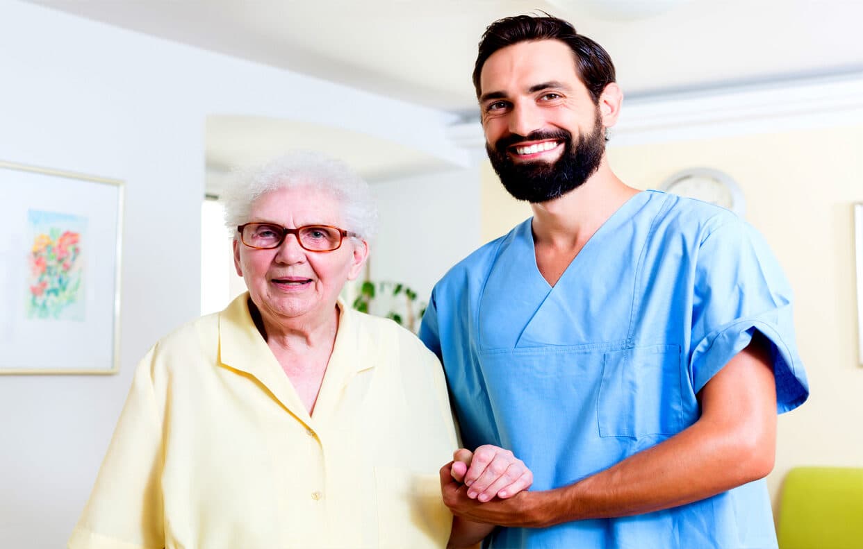 Qualified nurse with a resident in a care home